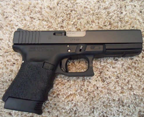 the best handgun for home defense .45 ACP Glock 21 on floor ground at home